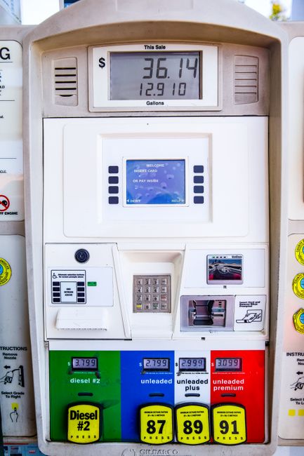 A digital fuel pump display showing a total of 36.14 dollars for 12.910 gallons of fuel. The pump features multiple payment options including a card reader with a blue and white interface, a keypad, a